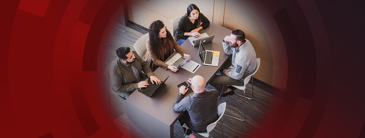 stock image: five professionals having a meeting around a table