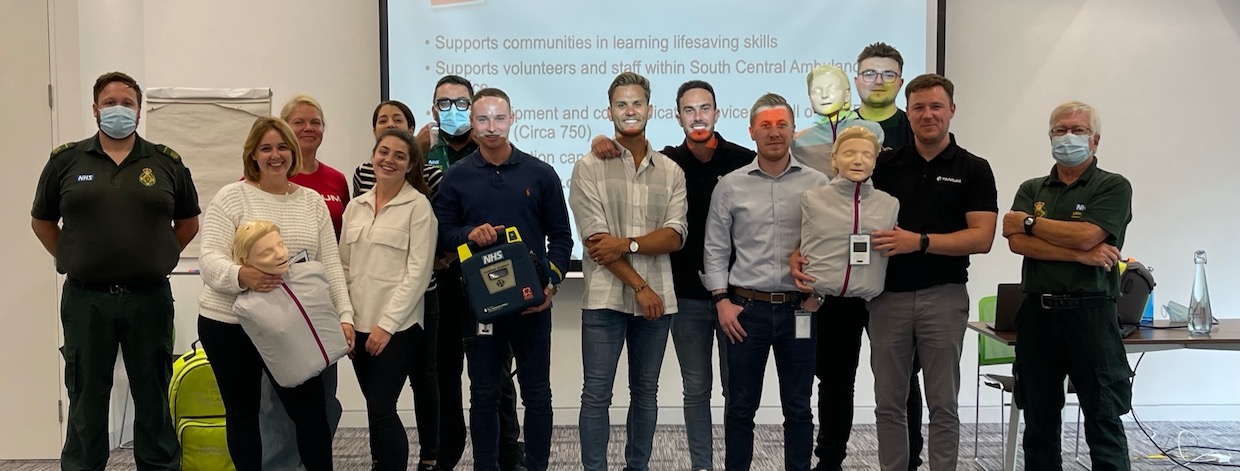 A group of a dozen Tanium UK team members posing for a photo in the office