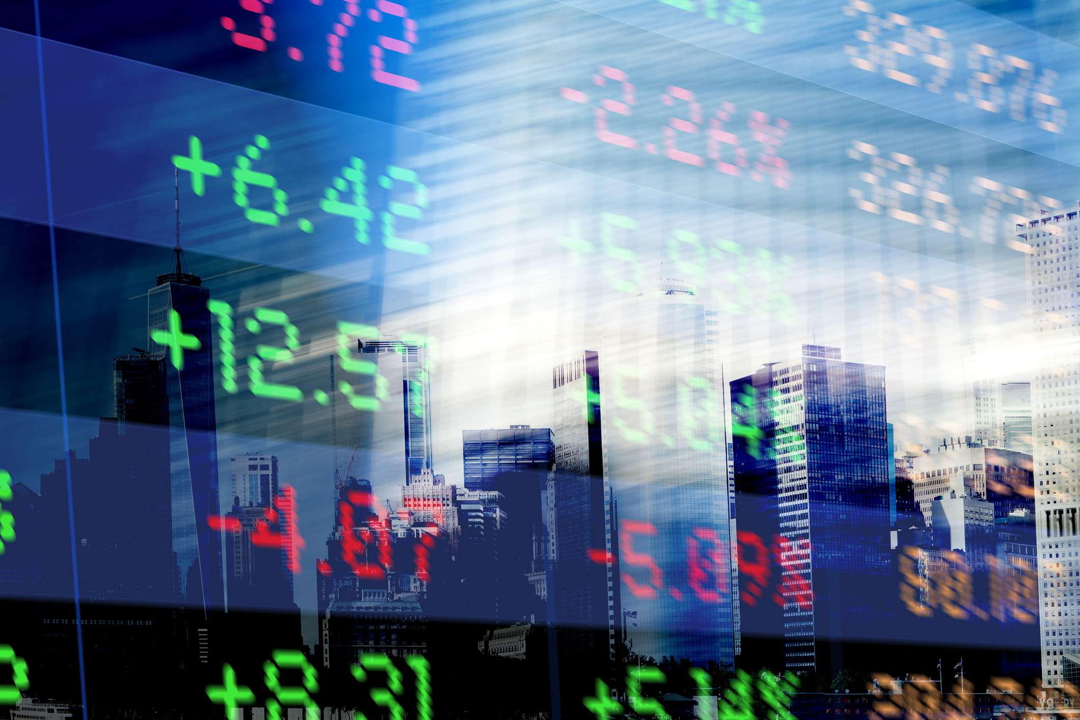 Photo of a city skyline reflected in an electric stock exchange sign